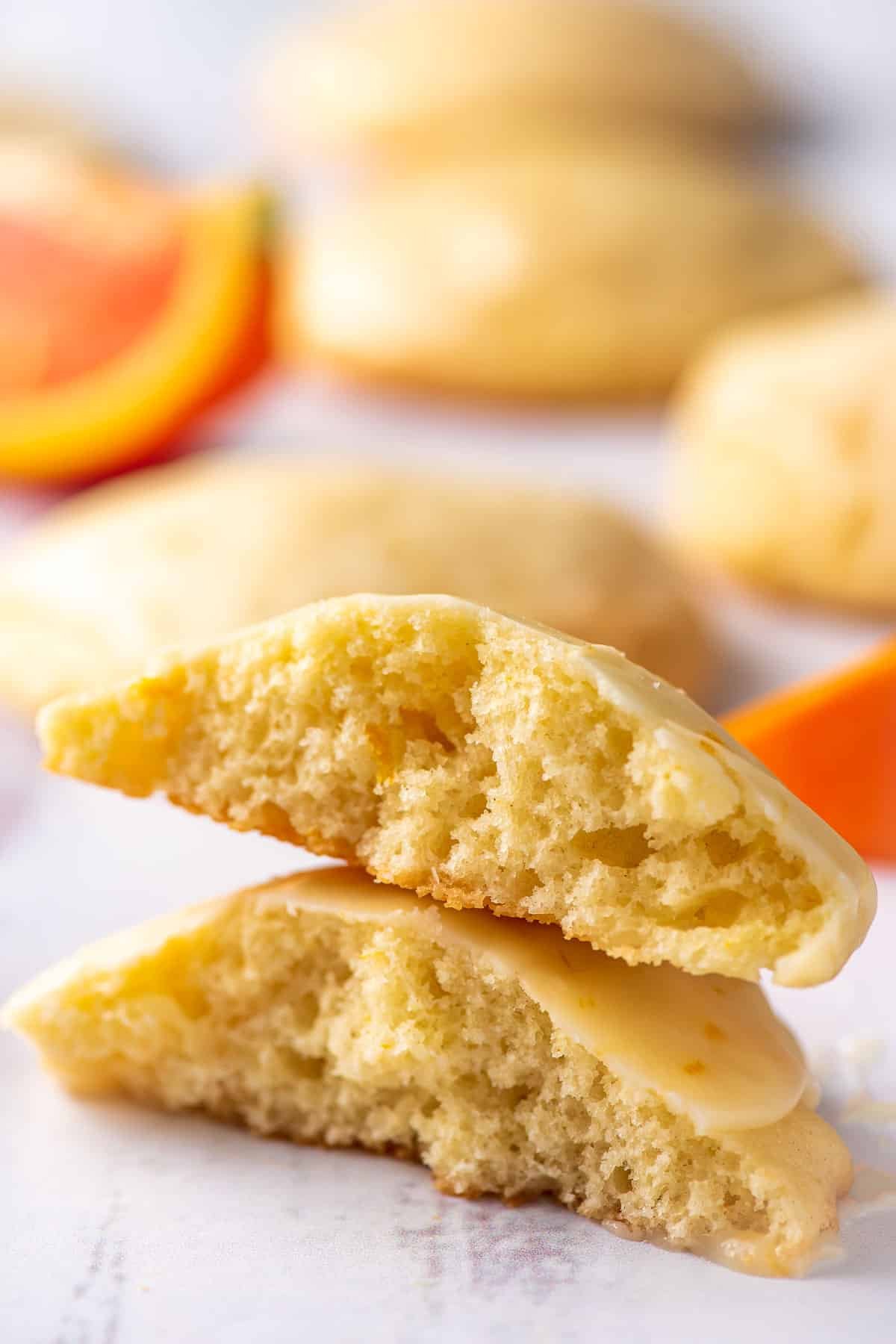 Orange cookie split in half and stacked to reveal the fluffy interior.