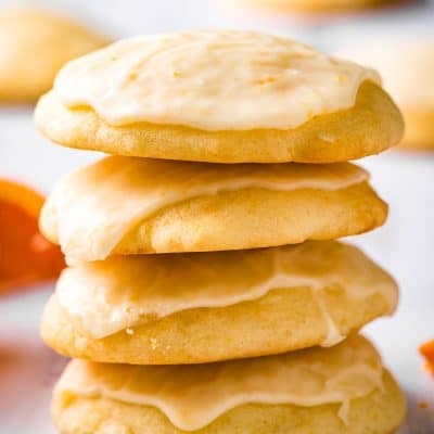 Stack of iced orange cookies.