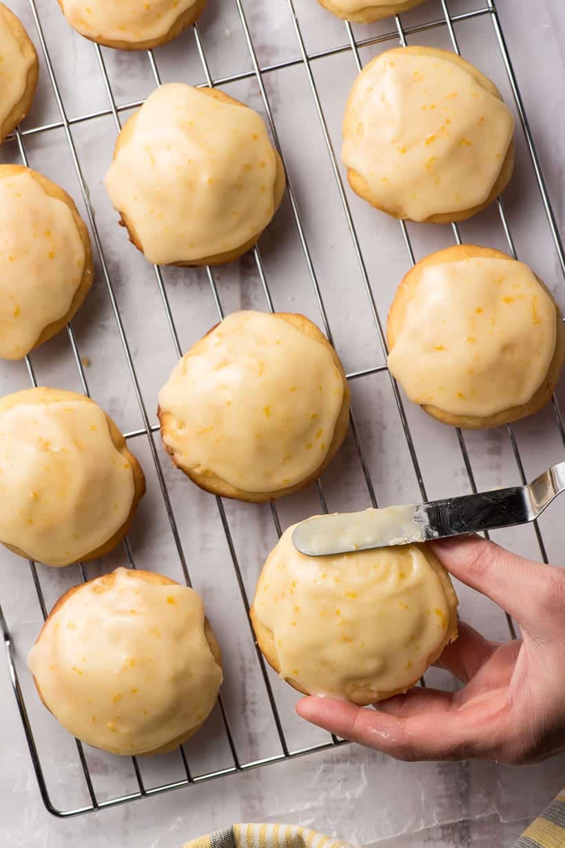 hand frosting orange cookies