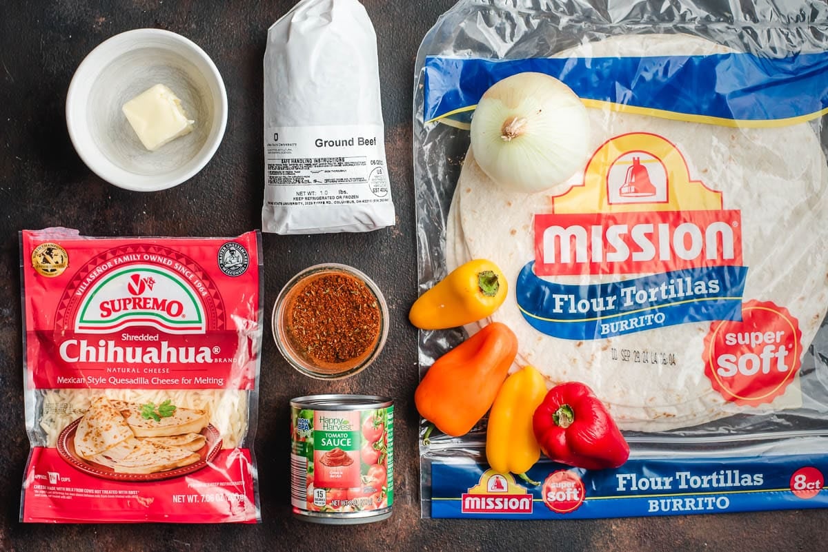 Large flour tortillas, chihuahua cheese, tomato sauce, taco seasoning, butter, peppers, onion, and ground beef.