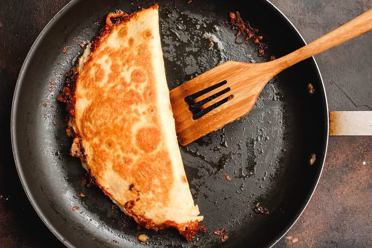 Browned and crispy ground beef and cheese quesadilla.