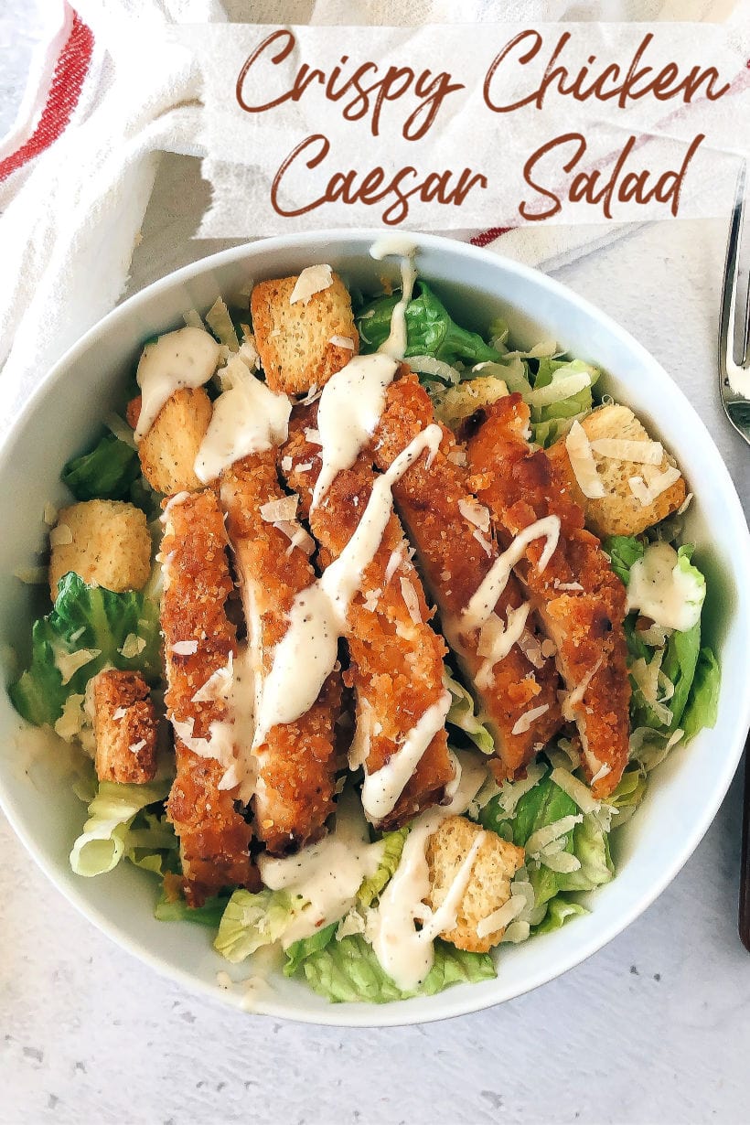 Crispy Chicken strips on top of a caesar salad