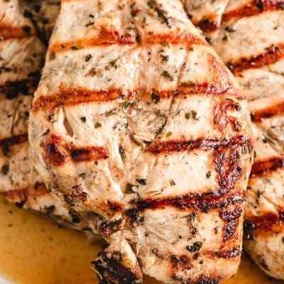 Grilled Italian dressing marinated chicken in a baking dish.