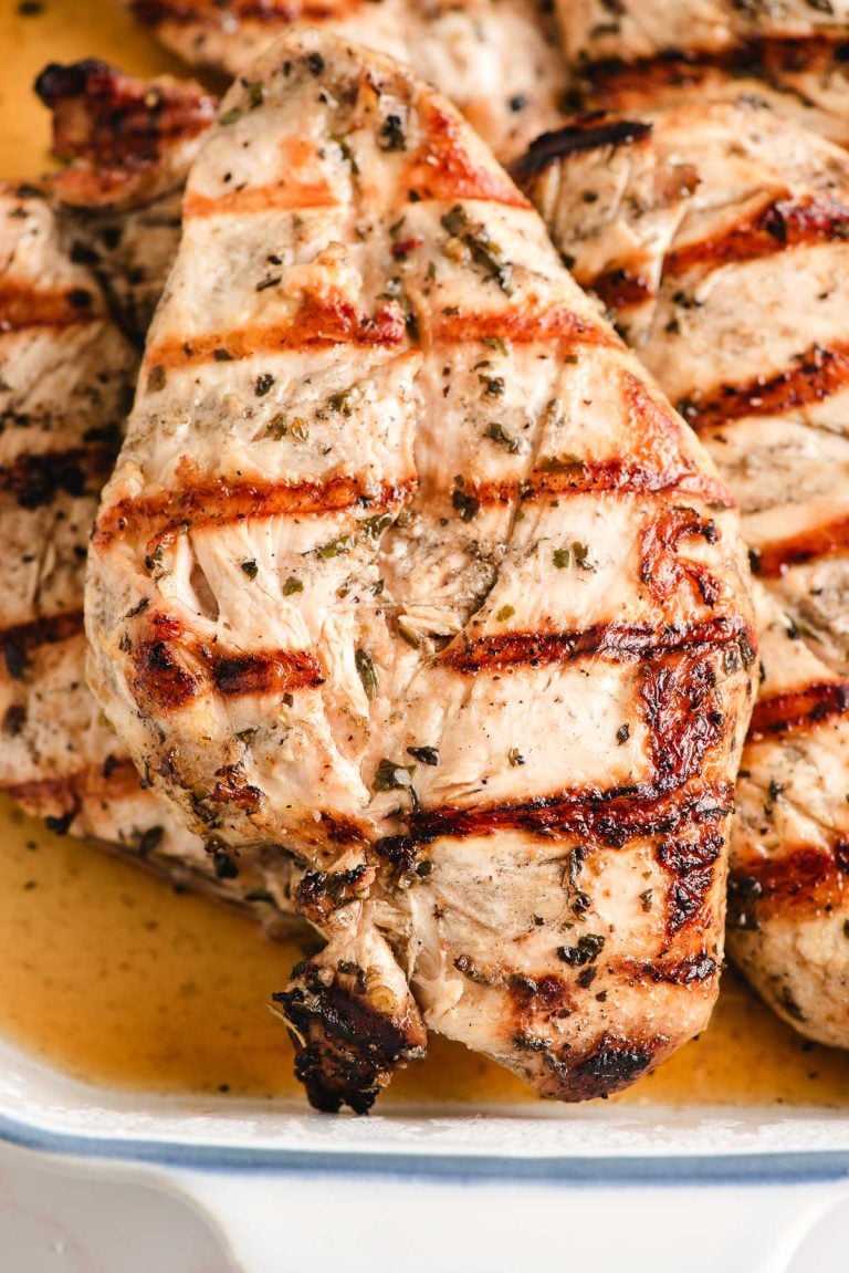 Grilled Italian dressing marinated chicken in a baking dish.