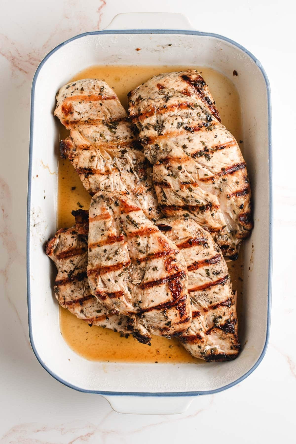Grilled Italian dressing chicken in a baking pan.