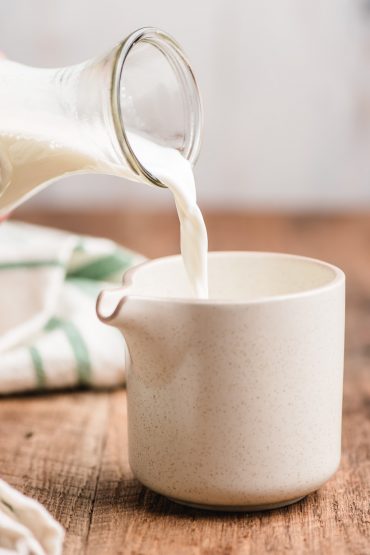 half and half being poured into a pitcher