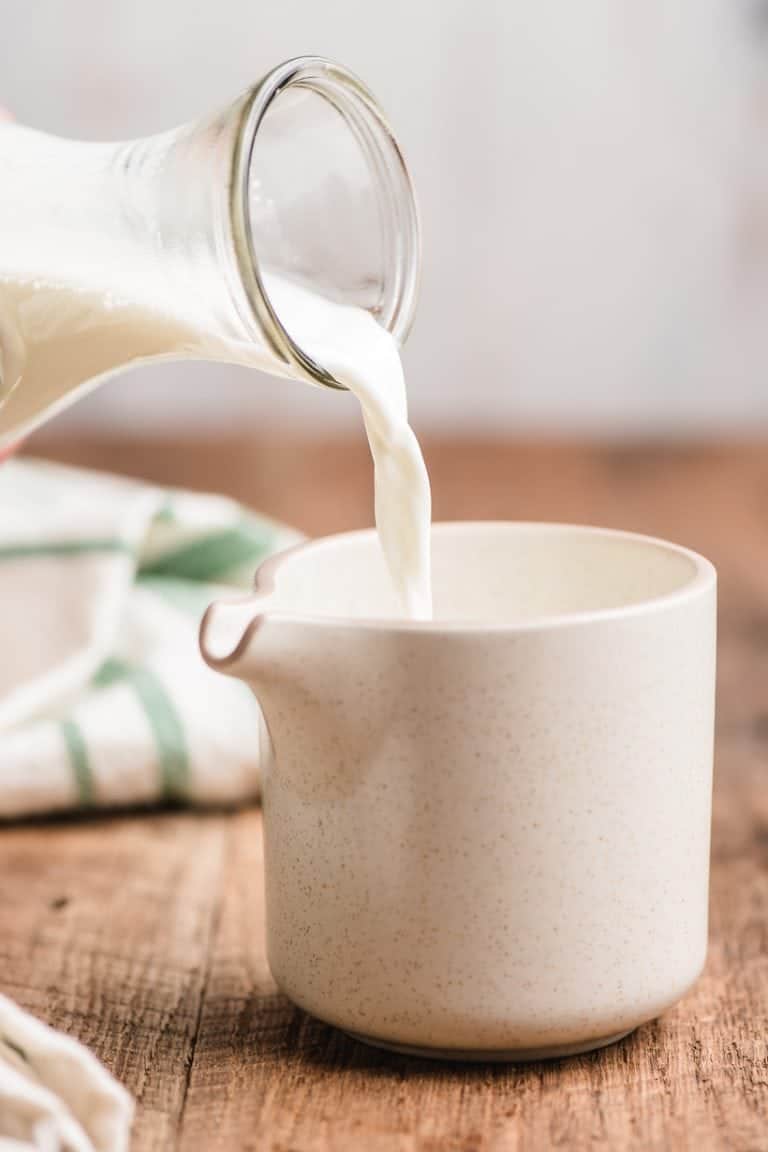 half and half being poured into a pitcher