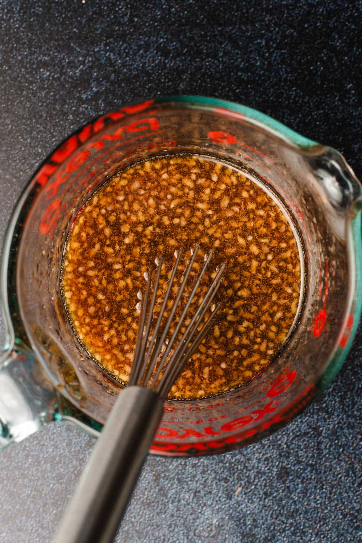 Asian chicken marinade whisked together in a glass measuring cup.