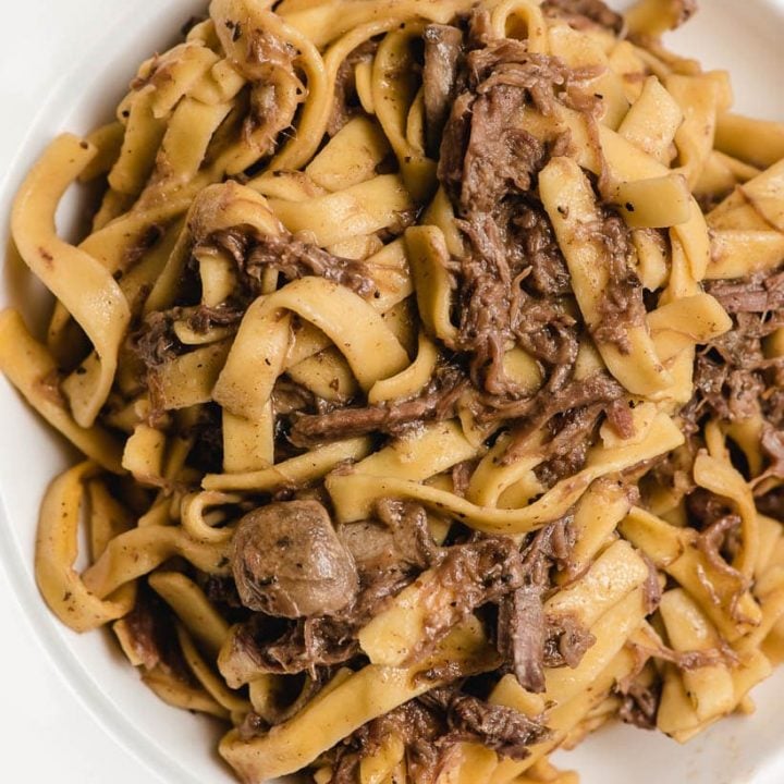 shredded beef and noodles in a white bowl