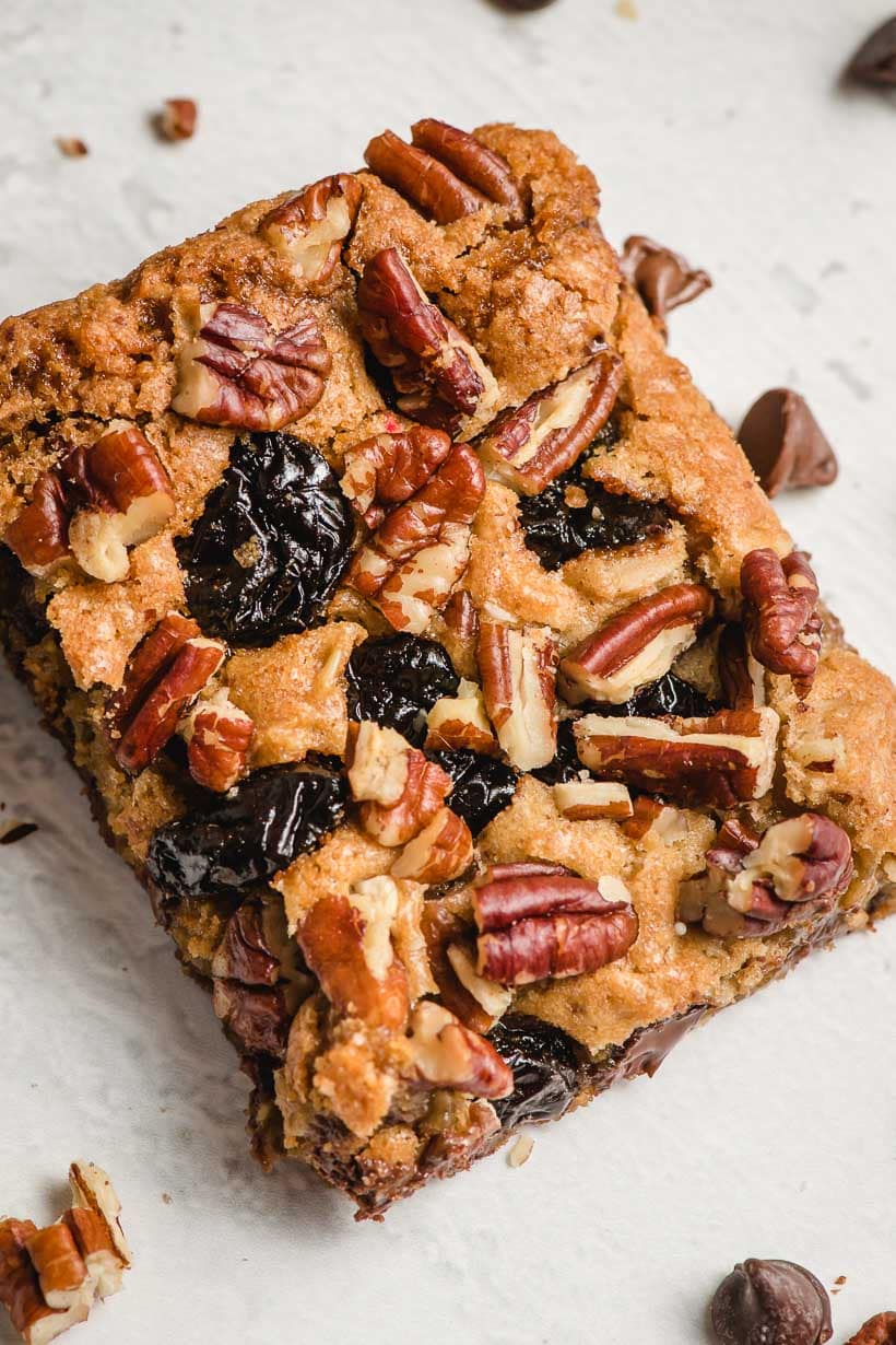 oatmeal chocolate chip cookie bar square with dried cherries and pecans on top