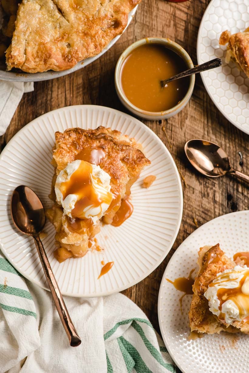 slices of apple pie topped with ice cream and caramel sauce