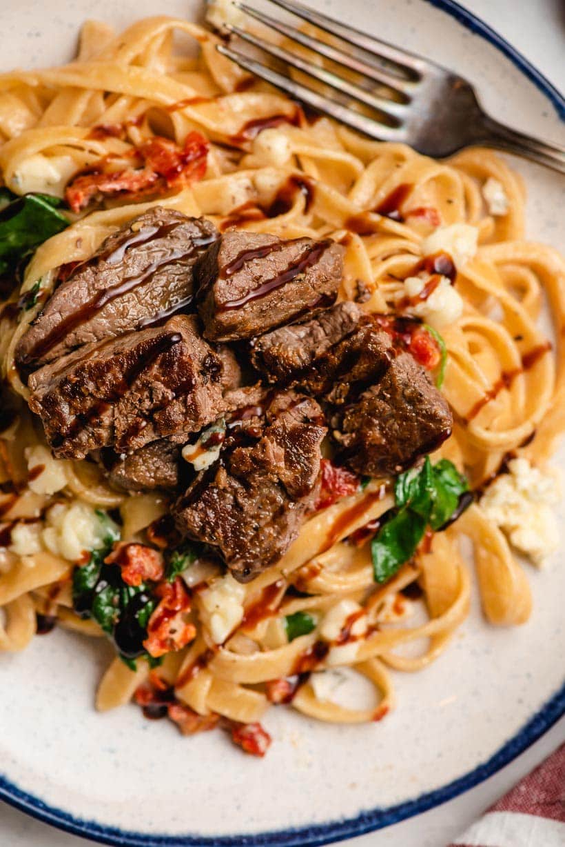 Steak on fettuccine noodles with gorgonzola crumbles