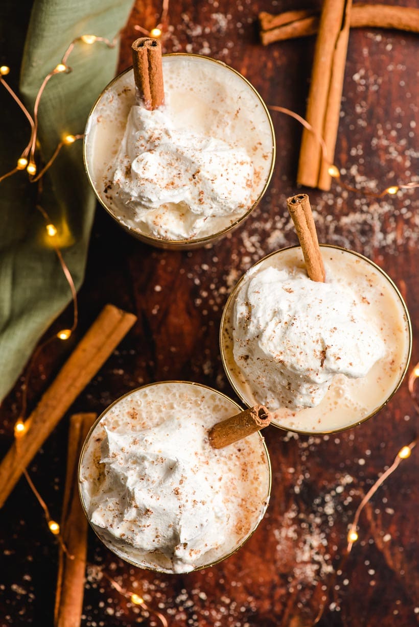 three glasses of eggnog with whipped cream