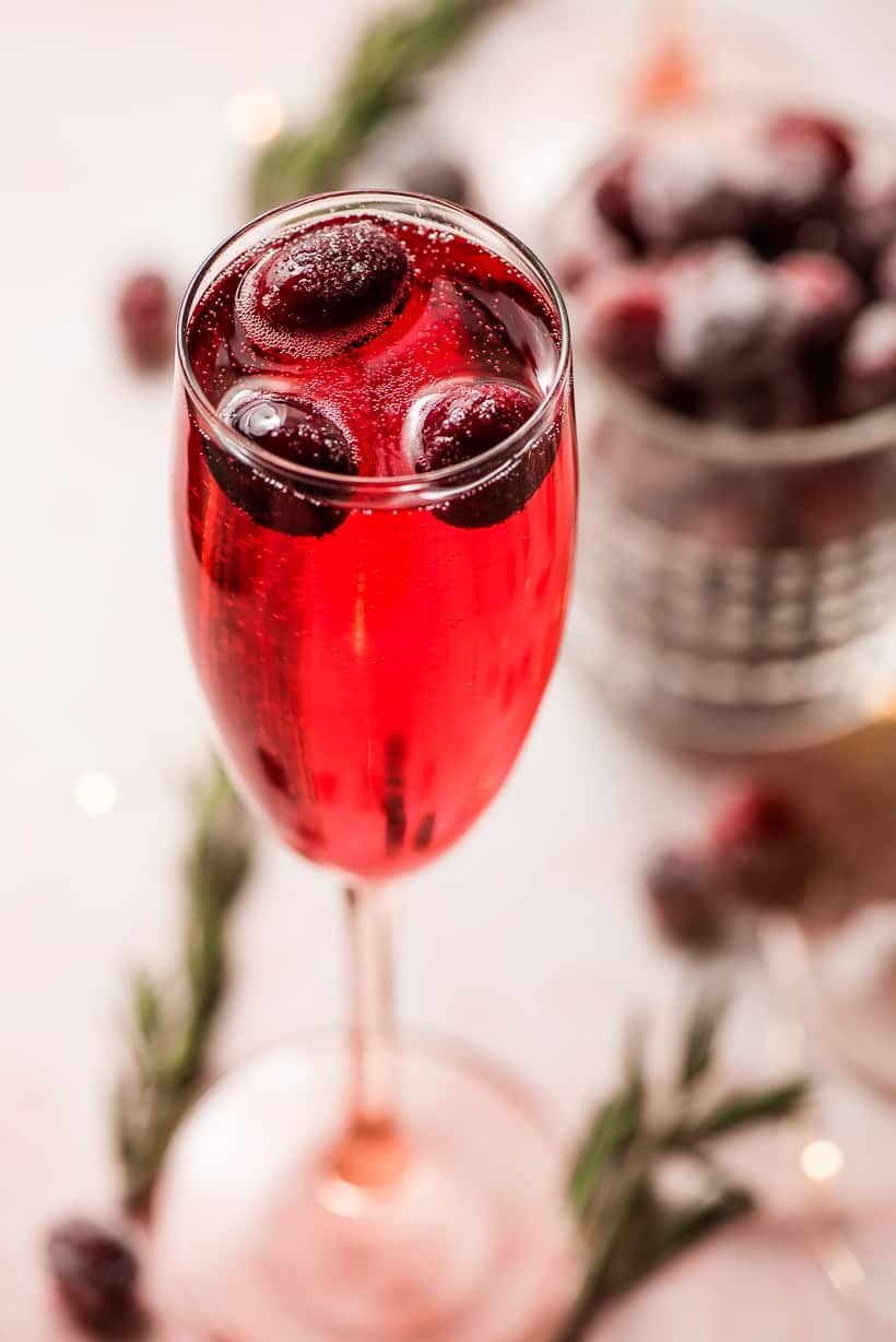 champagne glass filled with cranberry christmas mimosas