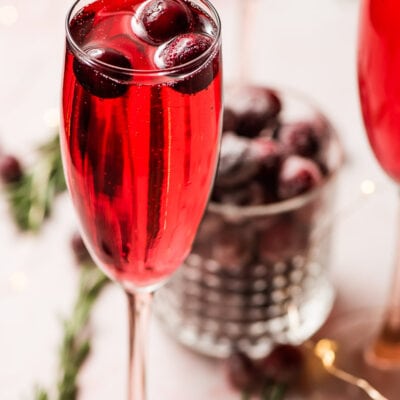 cranberry mimosas with sugared cranberry garnish