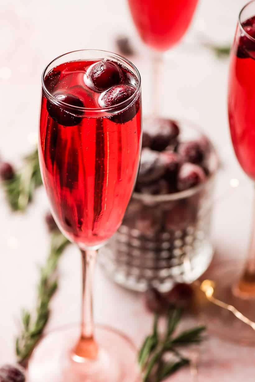 cranberry mimosas with sugared cranberry garnish