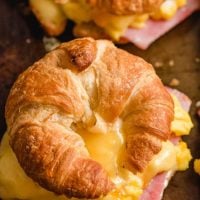 croissant sandwich with eggs, cheese, and ham