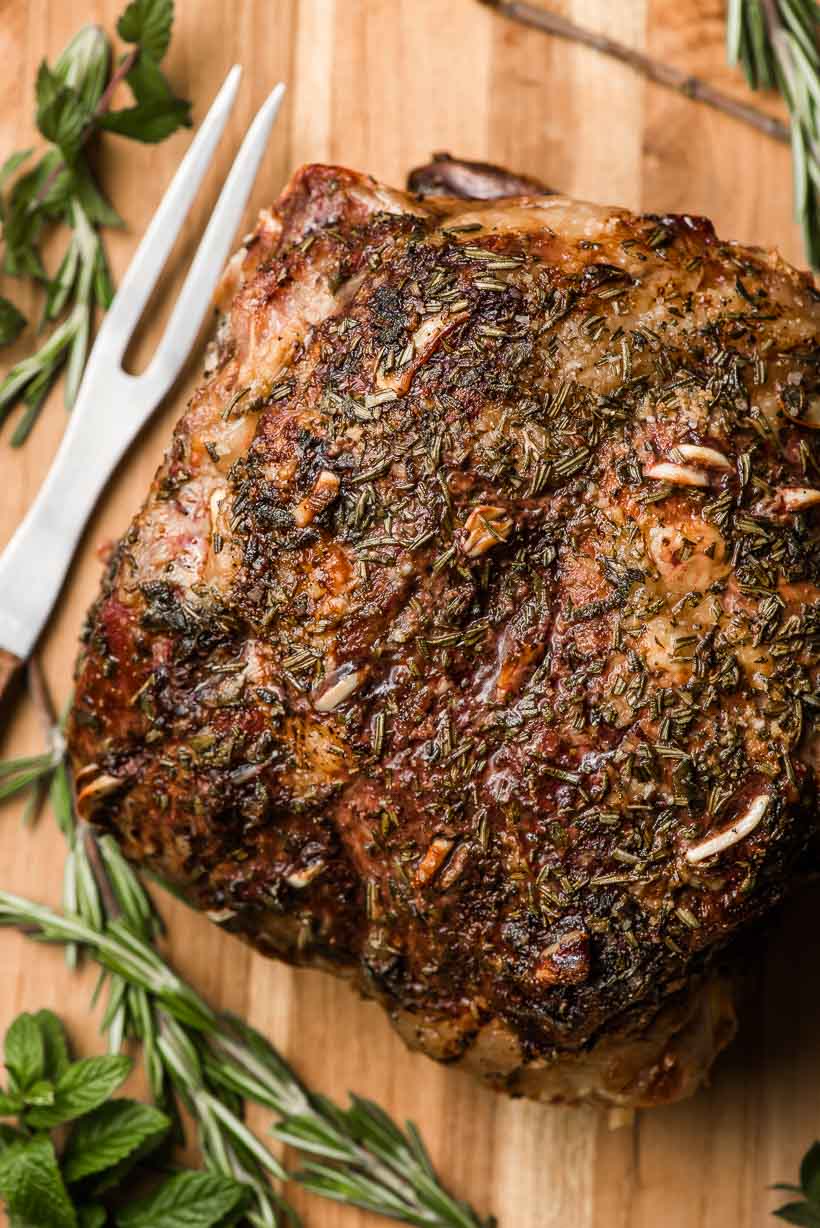 a roasted leg of lamb on a carving board