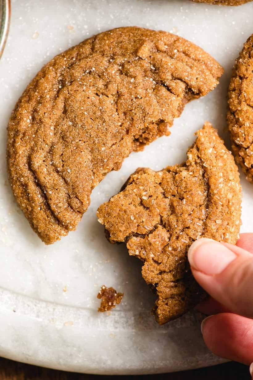 Hand reaching for a piece of Ginger Molasses Cookie