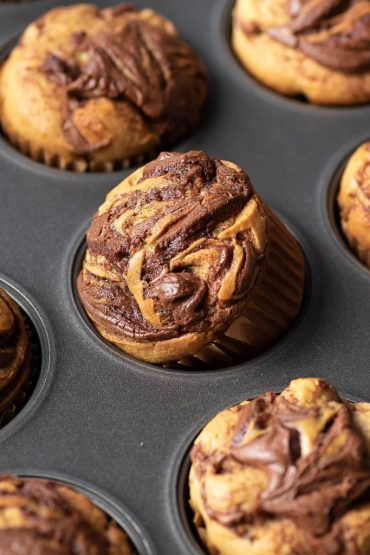 nutella swirled banana muffin in a tin