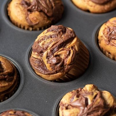 nutella swirled banana muffin in a tin