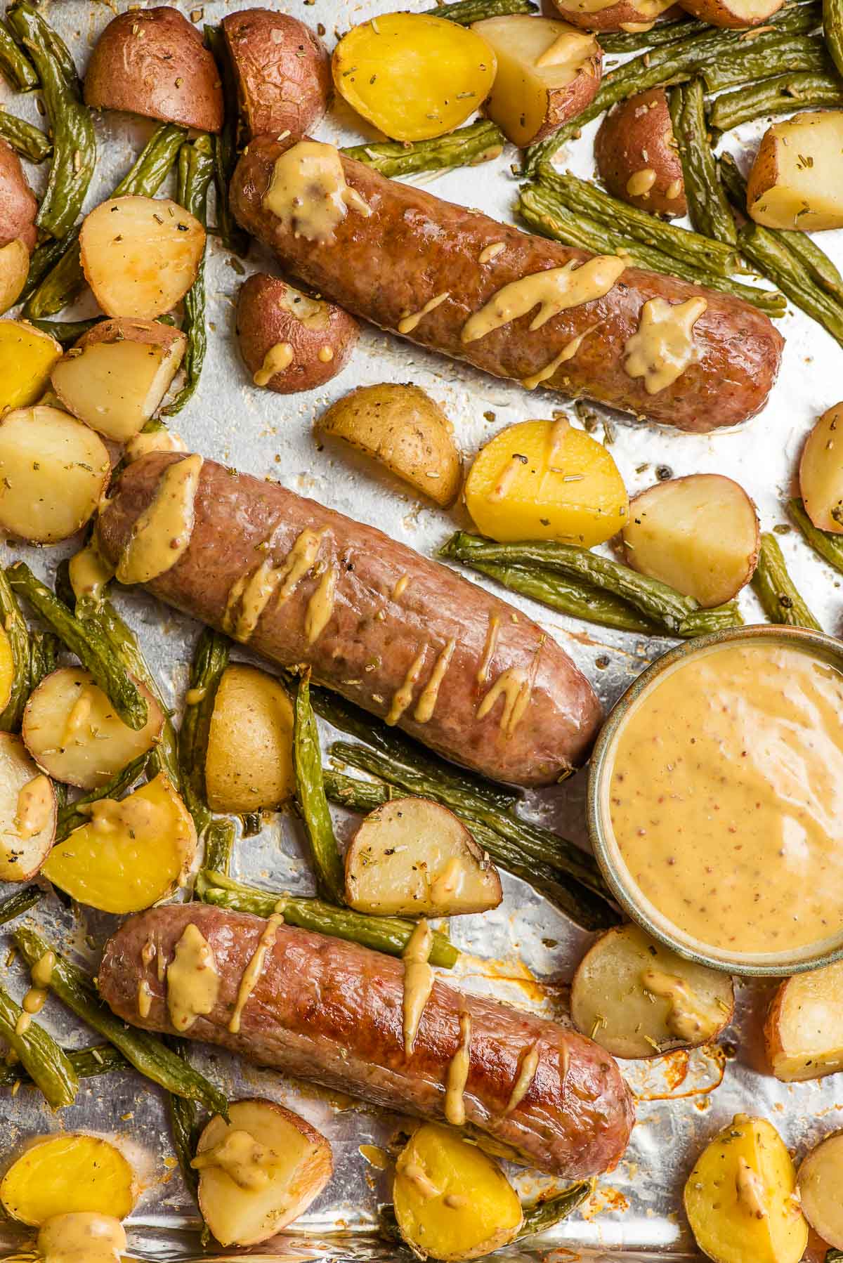 Baked Italian sausage, potatoes, and green beans drizzled with dijon mustard sauce.