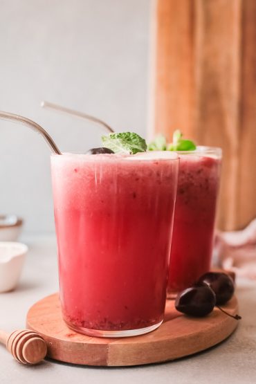 two glasses filled with peach cherry wine slushies