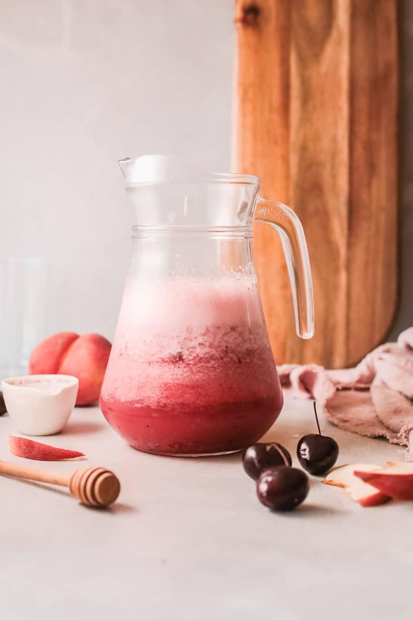glass pitcher filled with bright pink wine slushie
