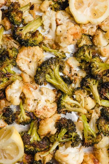 crispy baked cauliflower and broccoli on a baking sheet