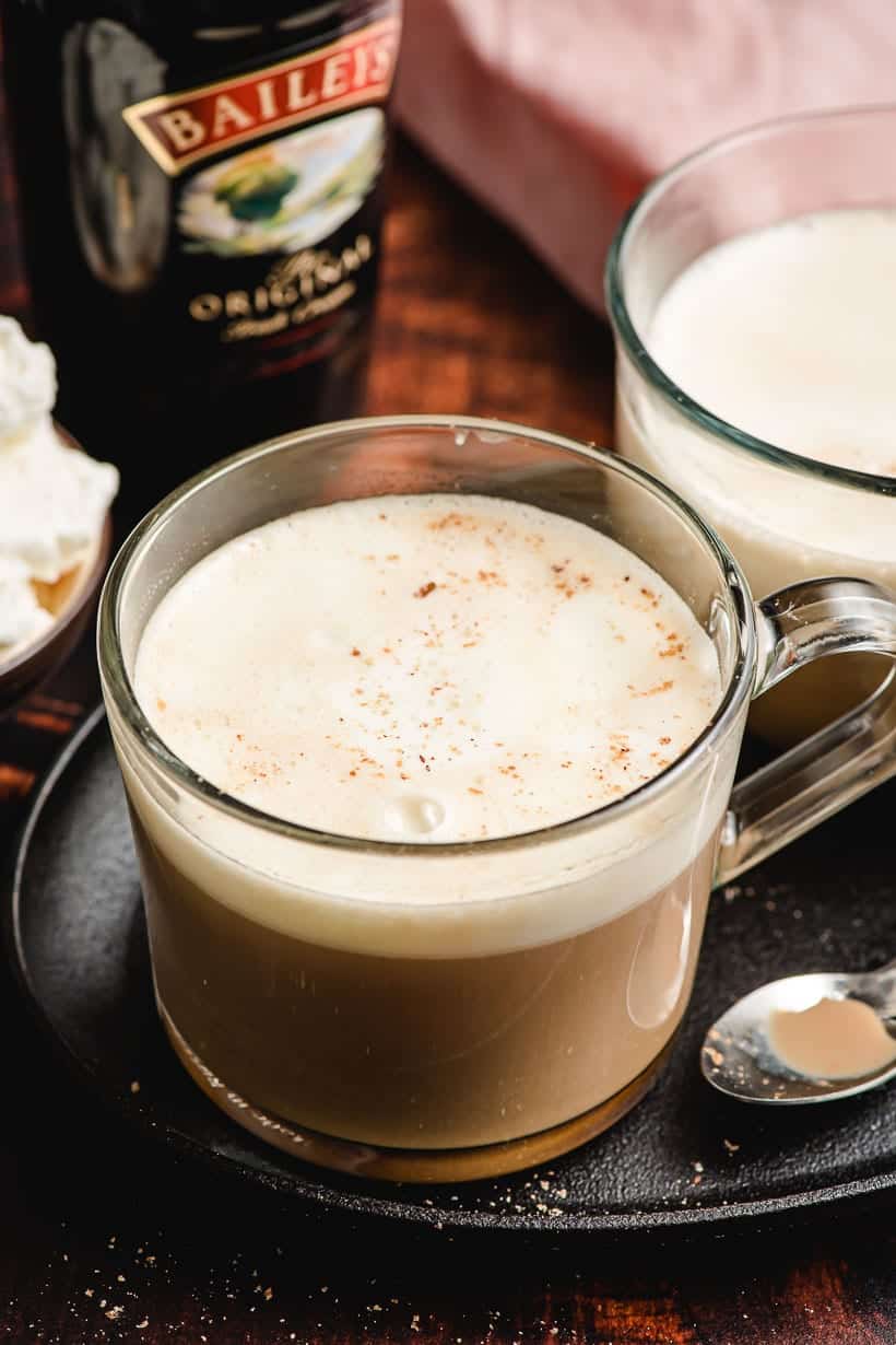 Irish Cream Coffee in a glass mug with whipped cream and nutmeg on top.