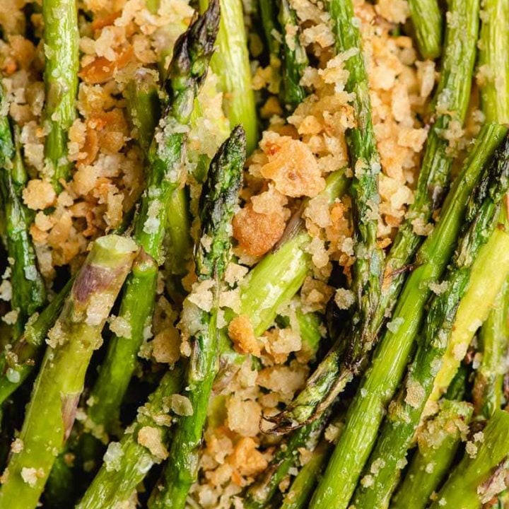 Up close image of fried asparagus with garlic butter breadcrumbs.