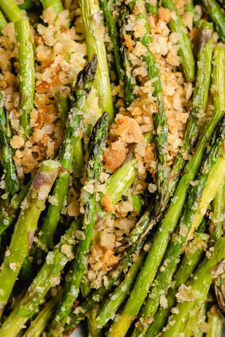 Up close image of fried asparagus with garlic butter breadcrumbs.