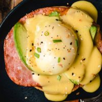 Ham, Avocado, Poached Eggs, and Hollandaise sauce on a bagel