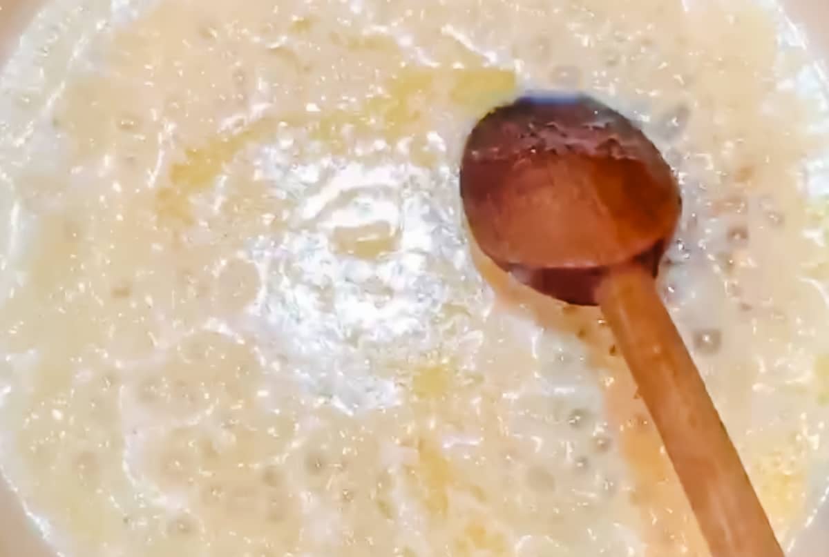 Butter and sweetened condensed milk bubbling in a pot.
