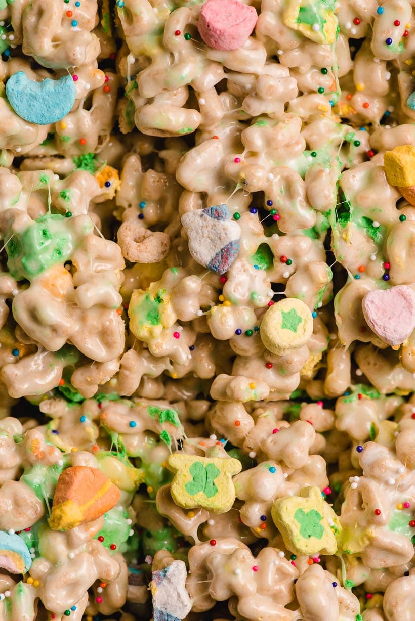 Up close image of Lucky Charms treats with leprechaun hats, pot of gold, and moon marshmallows on top.