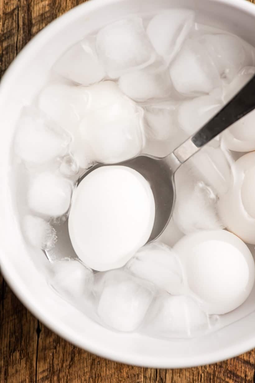 Sous vide poached eggs cooked in the shell getting an ice bath.