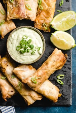 A platter of Southwest Air Fryer Egg Rolls with lime cilantro dip.