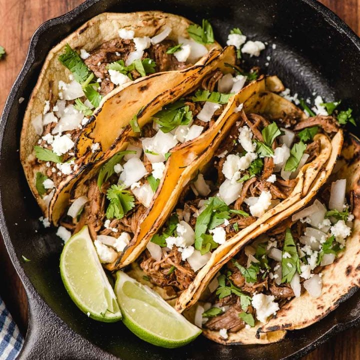 Four corn barbacoa tacos in a small cast iron skillet/