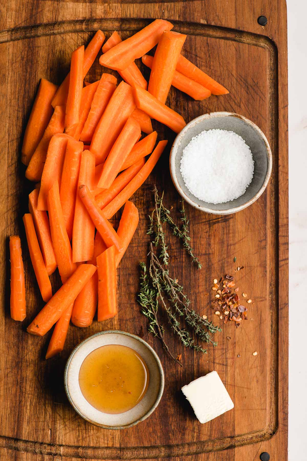 Ingredients prepared on a board for a carrot saute.