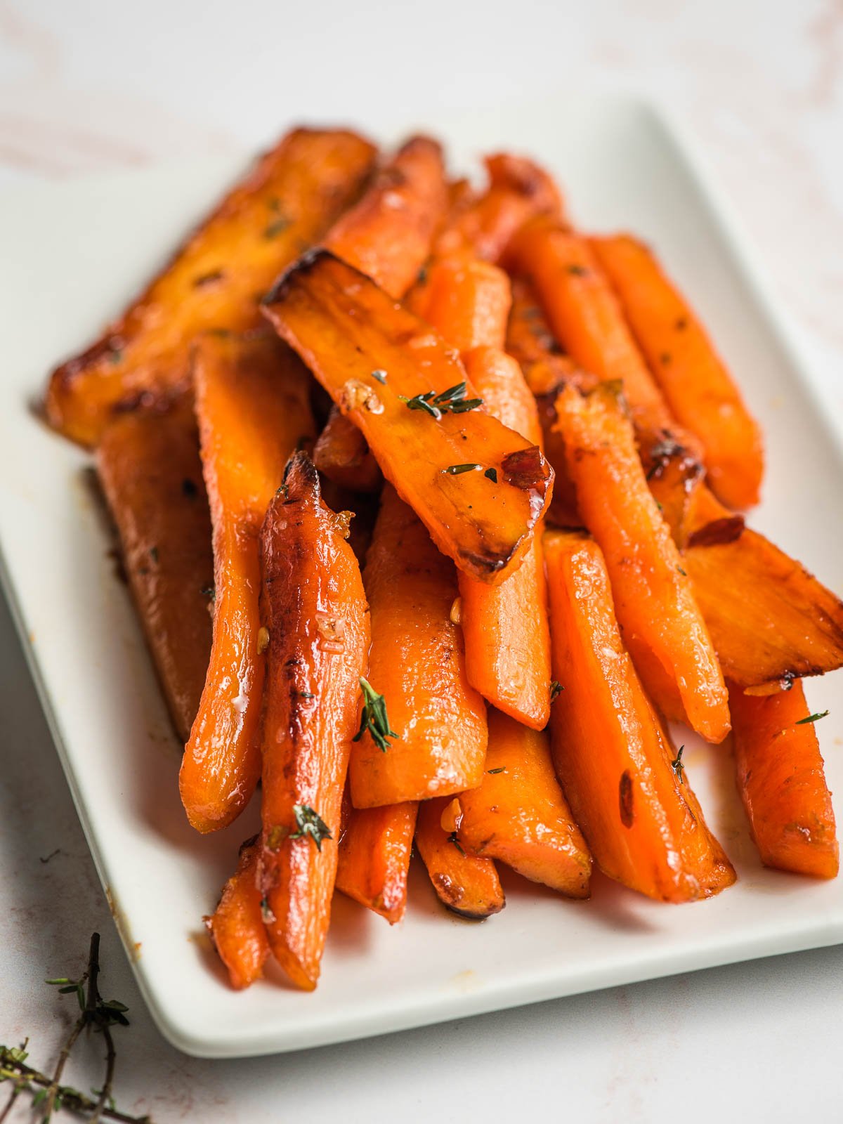 Sauteed Carrots with honey and thyme on a serving platter.