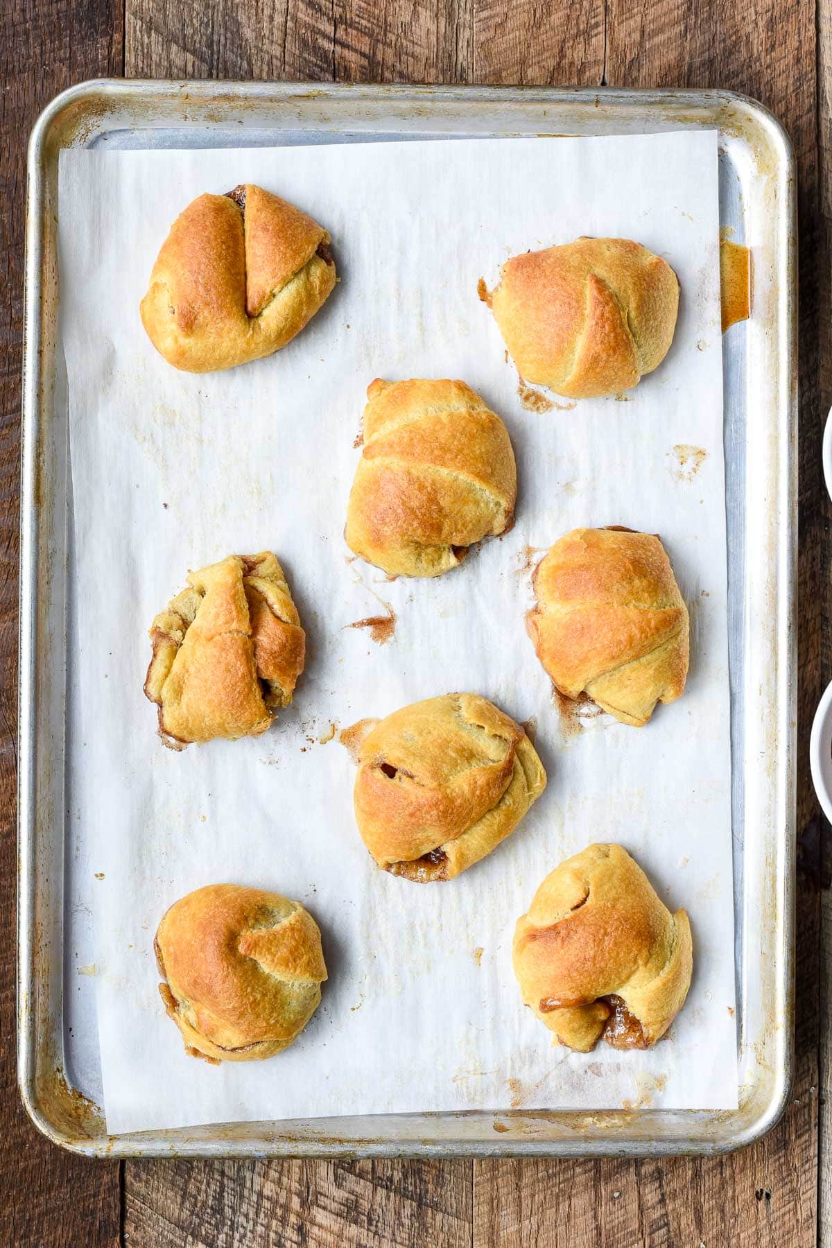 Sheet pan of baked resurrection rolls.