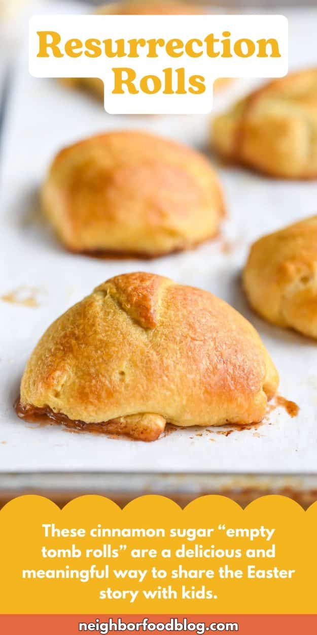 Freshly baked resurrection rolls on a parchment lined sheet pan.