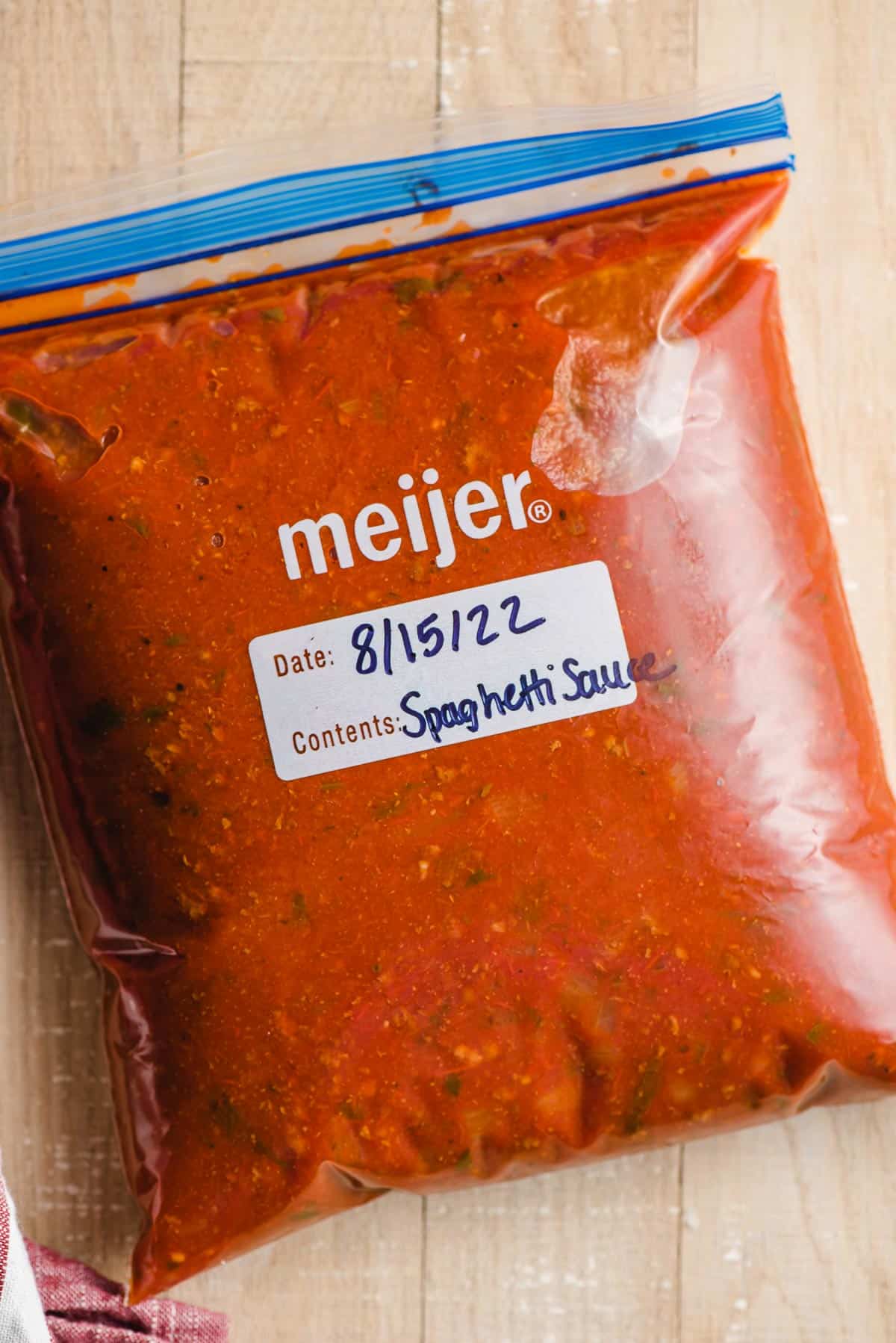 A ziplock bag filled with homemade spaghetti sauce.
