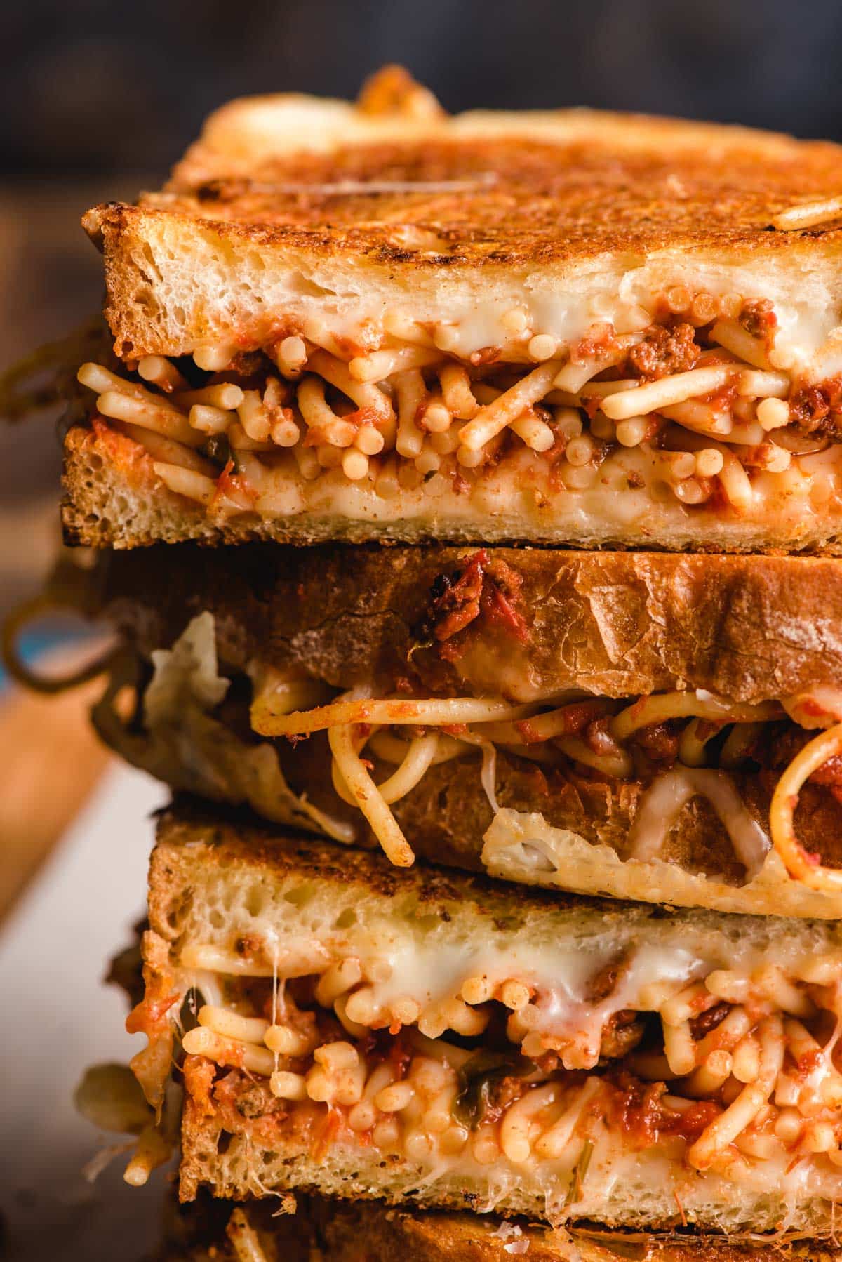 Spaghetti grilled cheese cut in half and stacked on top of each other.