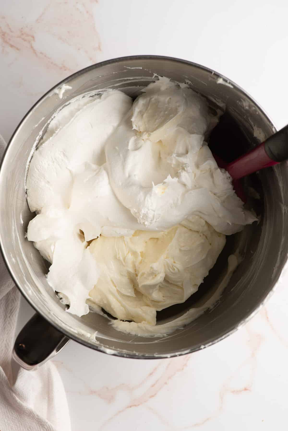 Cream cheese, sugar, and whipped topping in a mixing bowl.