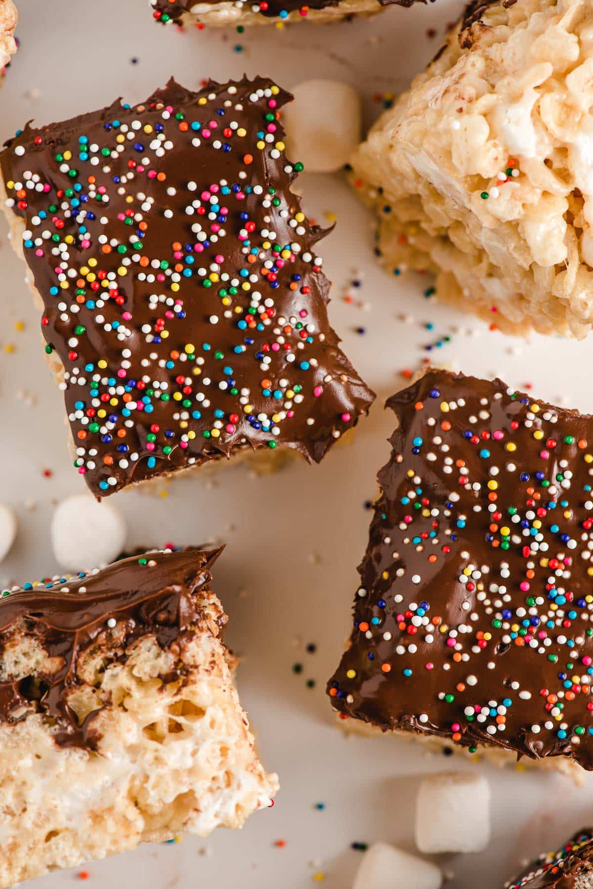 Chocolate Covered Rice Krispie Treats with sprinkles, sliced into bars.