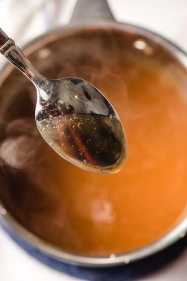 Spoon coated with apple cider syrup.