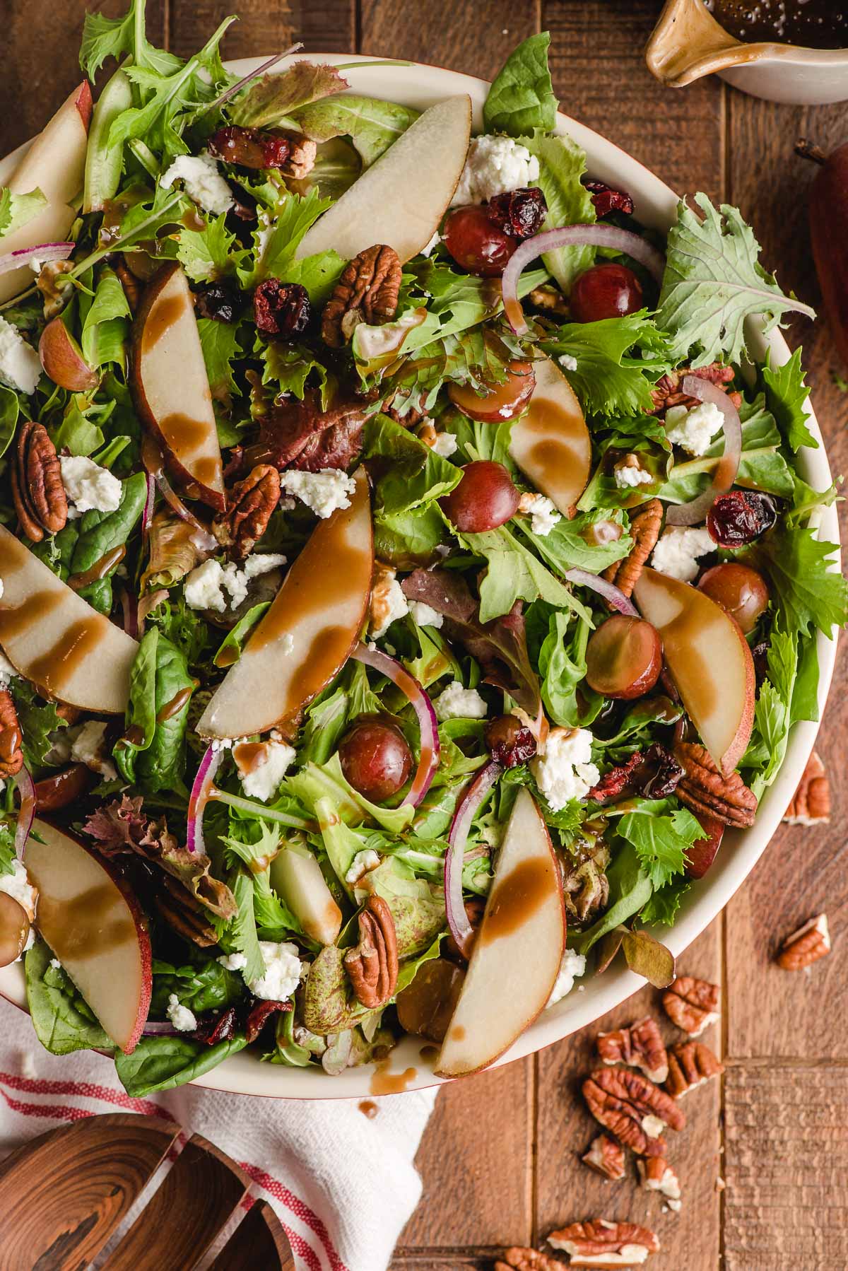 Autumn salad with maple dressing in a large white bowl.