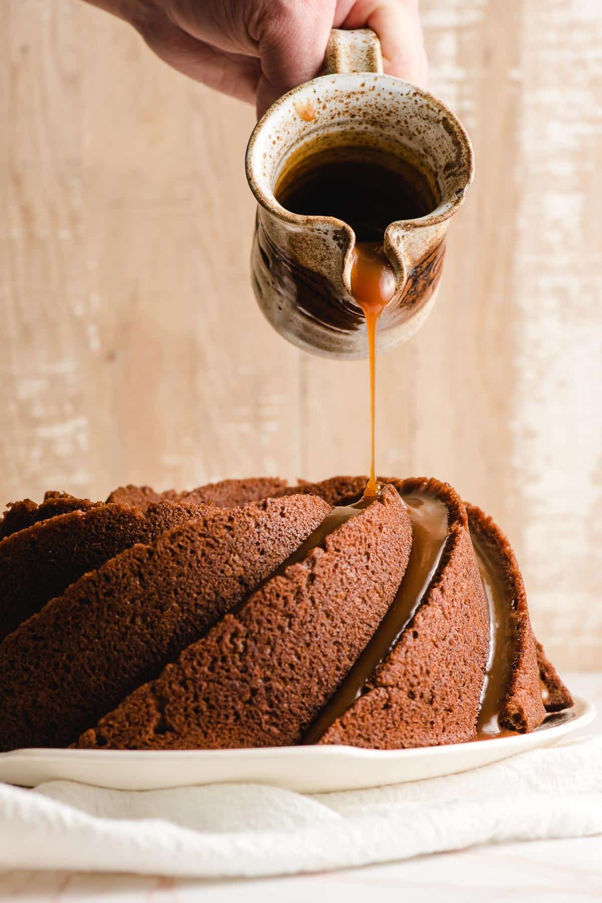 Caramel sauce is drizzled over a banana bundt cake.