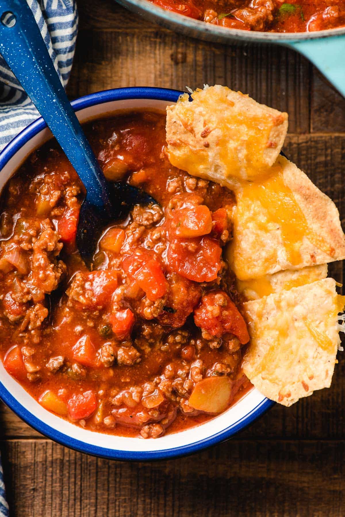 A bowl of Italian Sausage Chili with cheesy chips.